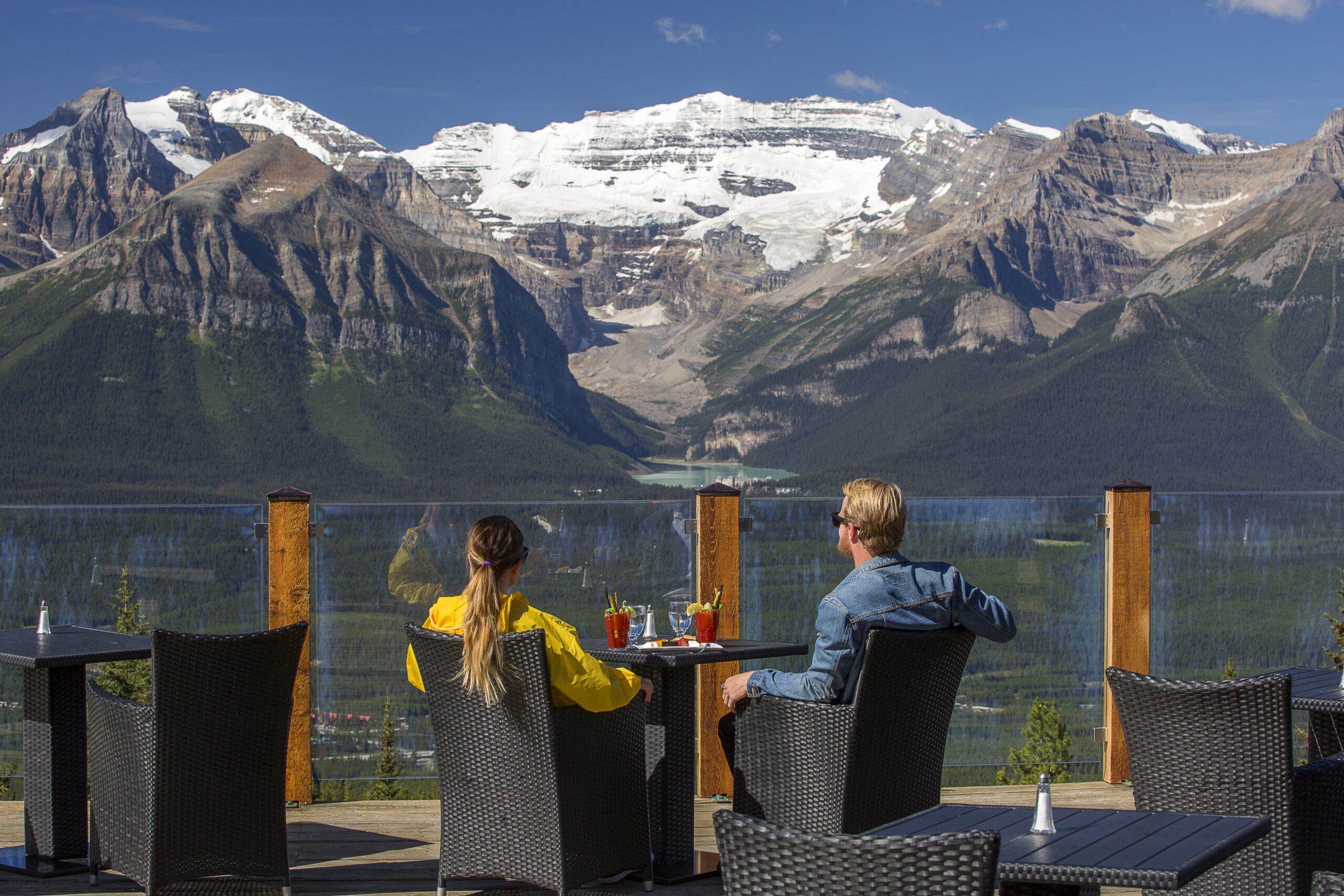 Couple enjoying the mountain view from Whitehorn Bistro at Lake Louise.